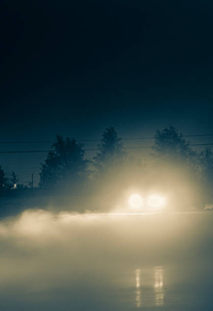 istock a car with fog lights on at night, when driving is impossible and dangerous with poor visibility, against the background of the night sky and slippery roads in winter on ice 2183153807