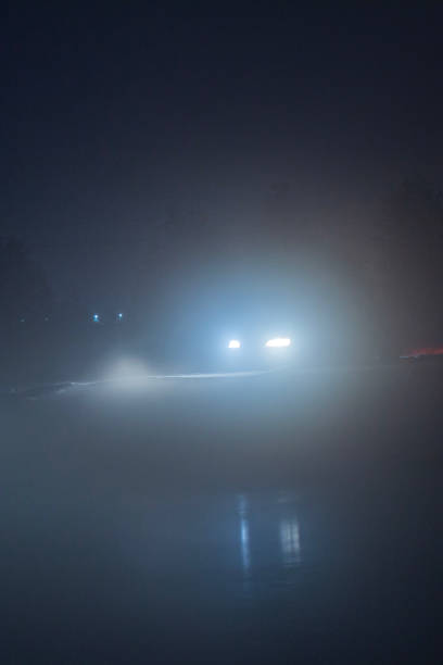 istock a car with fog lights on at night, when driving is impossible and dangerous with poor visibility, against the background of the night sky and slippery roads in winter on ice 2183153810