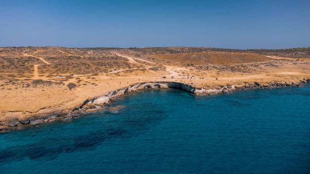 istock Aerial view of a rugged coastline with clear blue waters. 2183156567