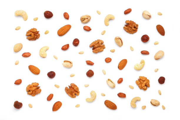 istock Background from different types of nuts and seeds. Isolated on white background 2183158350