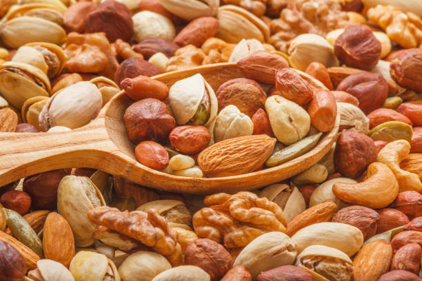 istock Nuts and seeds of different types with a wooden spoon closeup with selective focus 2183158580