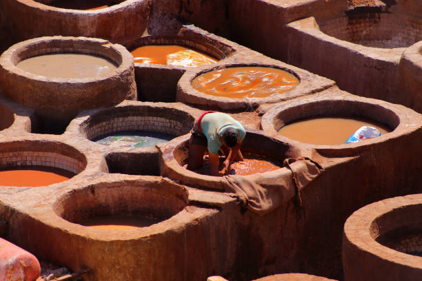 Fez, Morocco - October 7, 2008: Some leather workers at the Fez tannery; they use pretty much the same technique in vogue in the Middle Ages.