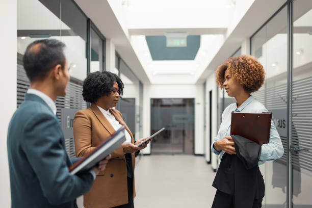 istock Business Team Discussion in Modern Office Corridor 2183159399