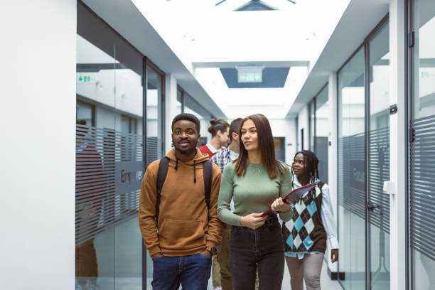 istock Cheerful Students Walking in Modern School Hallway 2183159482