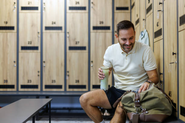istock Man holding water bottle, planning pre-workout session 2183161891