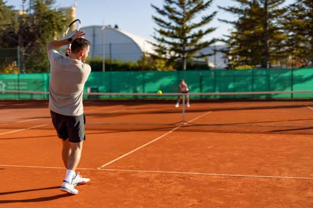 istock Man executes a forceful backhand on tennis court 2183162299