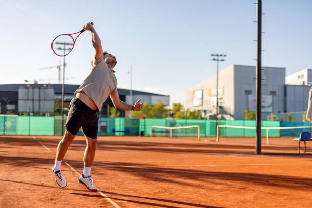 istock Male athlete leaping for a dynamic tennis serve 2183162359