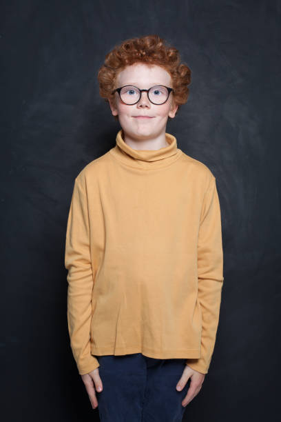 istock Smiling little boy kid in casual clothes over black background 2183164310