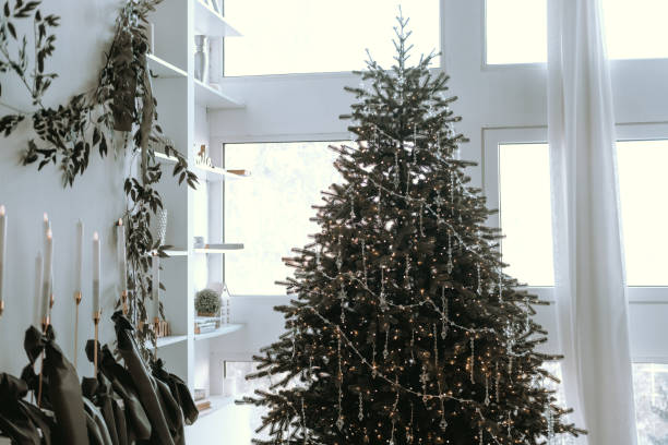istock Cozy indoor Christmas tree adorned with lights and decorations in a modern space 2183164502
