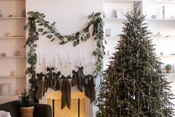 Cozy holiday decoration with a Christmas tree and elegant fireplace garland