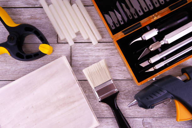 istock Set of DIY tools on a white wooden plank, directly above. 2183170607