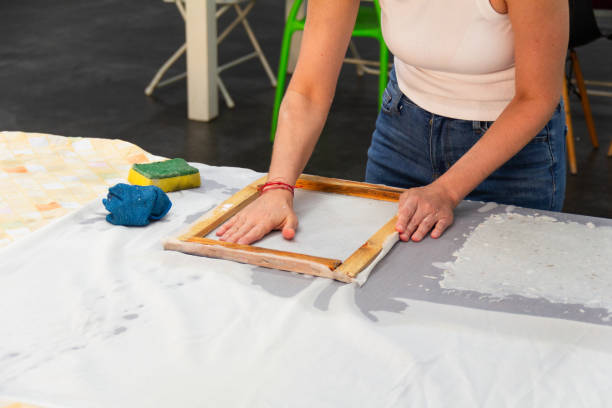 istock Unrecognizable person hands in the process of making handmade recycled paper with a deckle. Eco-friendly and zero waste concept. 2183170643