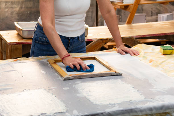 istock Unrecognizable woman artist creating recycled paper sheets in a bright studio, showcasing the beauty of sustainability through hands-on craftsmanship in the afternoon light 2183170797