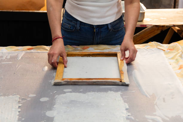 istock Unrecognizable woman artist skillfully creating handmade recycled paper sheets in a creative workspace, sustainable and reusable materials concept 2183170955