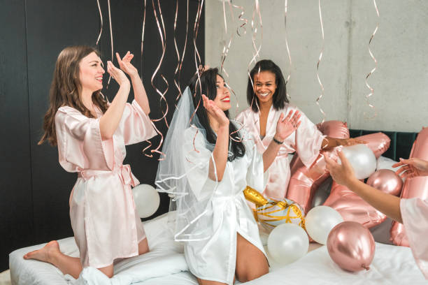 istock Diverse Bridesmaids Bonding with Hispanic Bride in Hotel Room 2183178959