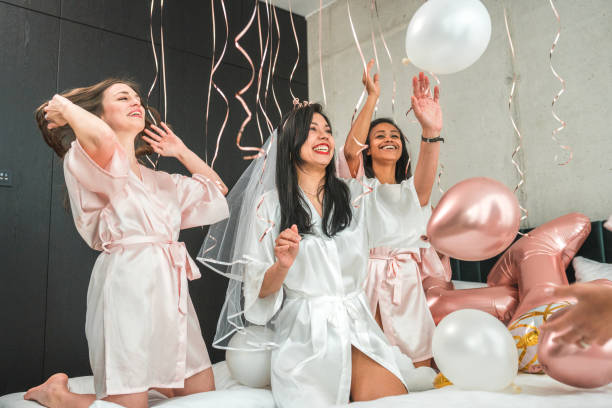 istock Hispanic Bride and Bridesmaids Play with Balloons 2183178965