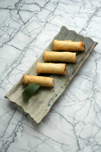 istock Deep fried spring rolls on a marble table background with copy space, close-up. Asian food menu 2183180185