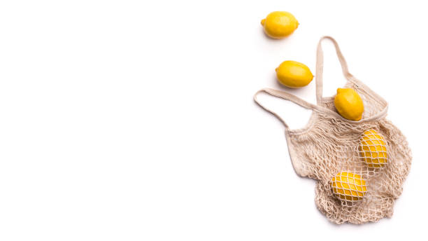 istock Flying fresh lemons outside eco bag on white background 2183180878