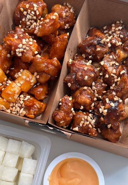 Crispy Korean fried chicken, perfectly glazed with a sweet and spicy sauce. Ideal for food photography and menus, showcasing the irresistible crunch and flavor of this beloved dish.