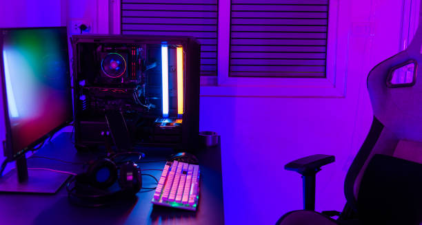 istock A computer setup with a purple light dark background, games transmission modern equipment, modern gaming PC on desk with keyboard mouse monitor 2183189954