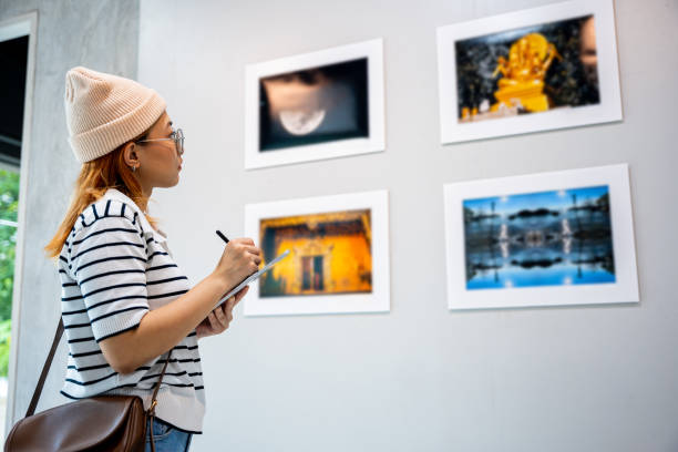 istock Young person at photo frame write digital book at show exhibit artwork 2183189964