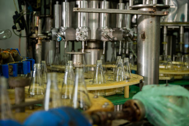 istock Empty glass bottles on a conveyor indicate a modern distillery's alcoholic beverage production and bottling 2183190019