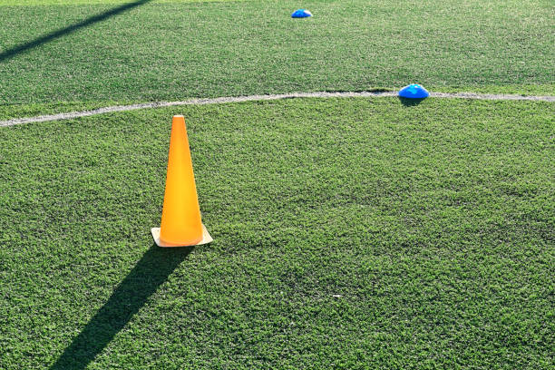 istock artificial green grass soccer field with orange training cones 2183191532