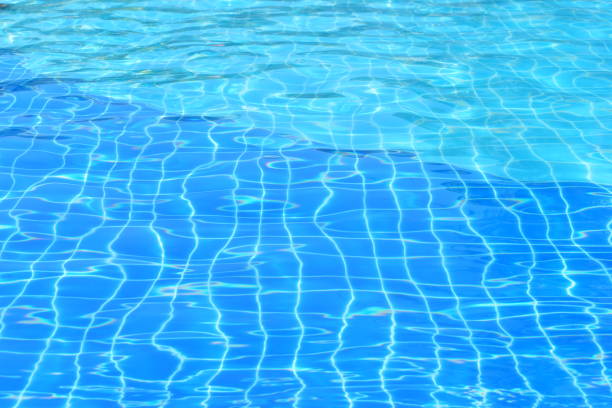 Ripples on the surface of the water in a blue swimming pool.