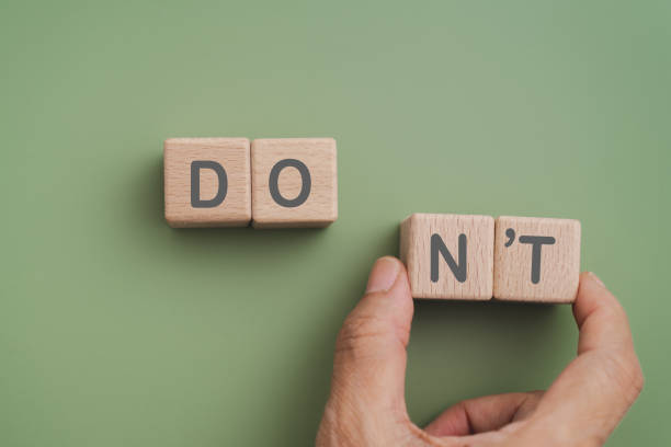 istock Hand move wooden cube blocks with NT text on green background. For Do's and Don'ts concept 2183192236