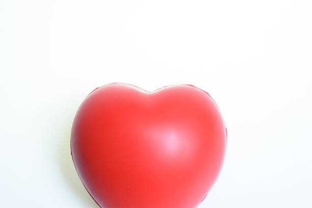istock single red stress ball isolated on white background, heart shape toy 2183192512