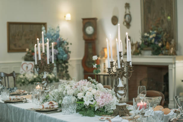 istock Elegant table setting with beautiful flowers on the table, gold decorations, candles, holiday table decorations 2183199872