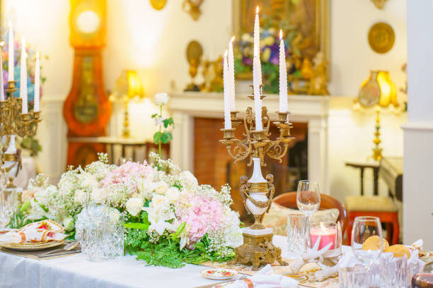 istock Elegant table setting with beautiful flowers on the table, gold decorations, candles, holiday table decorations 2183199881