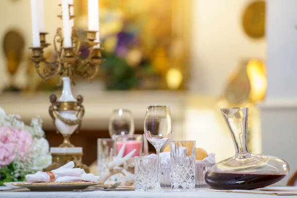 Elegant table setting with beautiful flowers on the table, gold decorations, candles, holiday table decorations