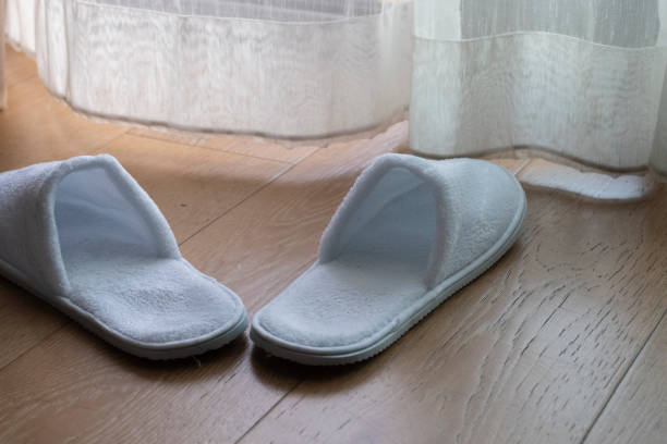 hotel slippers on wood floor