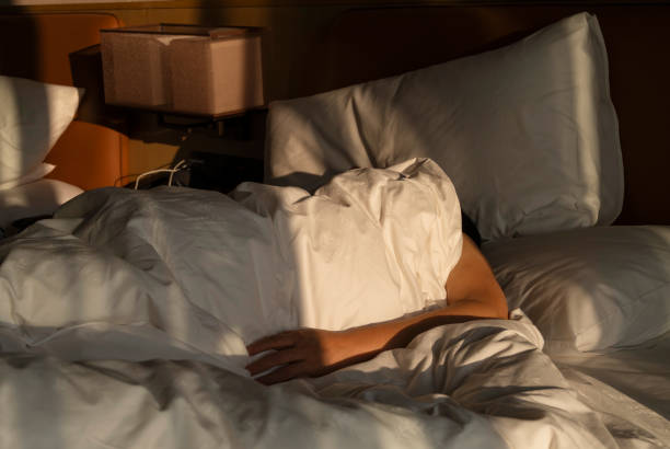 istock woman lying on bed in the dawn sunlight 2183202777