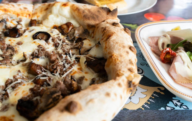 istock eating truffle mushroom pizza 2183204778