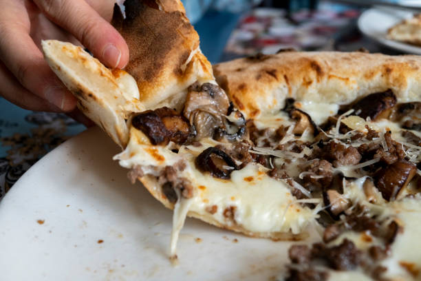 istock eating truffle mushroom pizza 2183204810