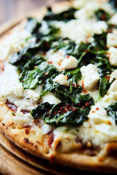 istock Pizza with mozzarella cheese and spinach. Close up. 2183206524