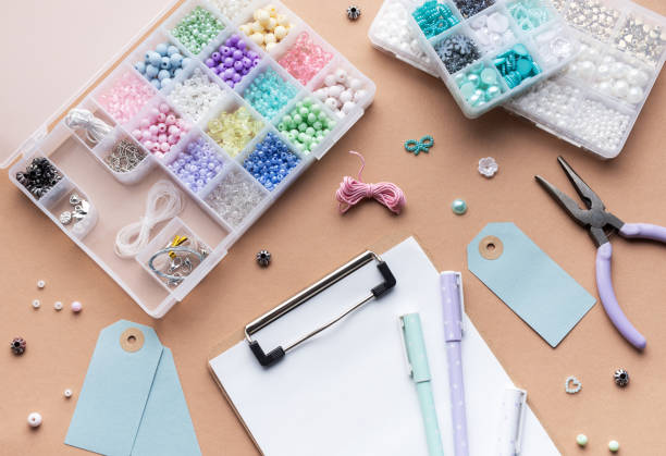 istock Crafting supplies arranged on a workspace with beads, tools,  tags for personalized jewelry making 2183207469