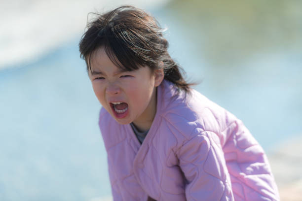A young girl crying with tears