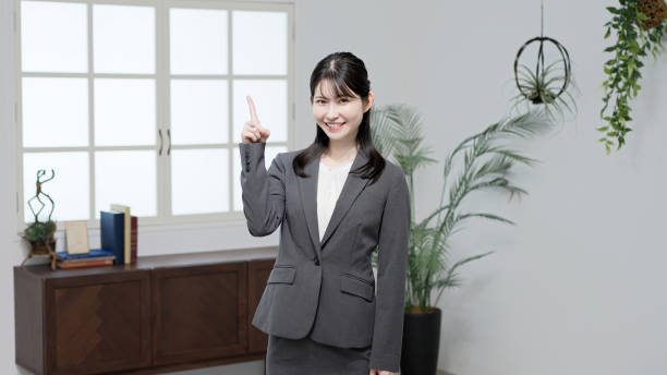 istock Asian businesswoman pointing with a smile 2183207704
