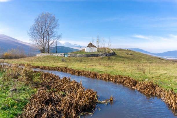 Scenery. View of the mountains, fir forest, village and bench in the highlands on a sunny, summer day