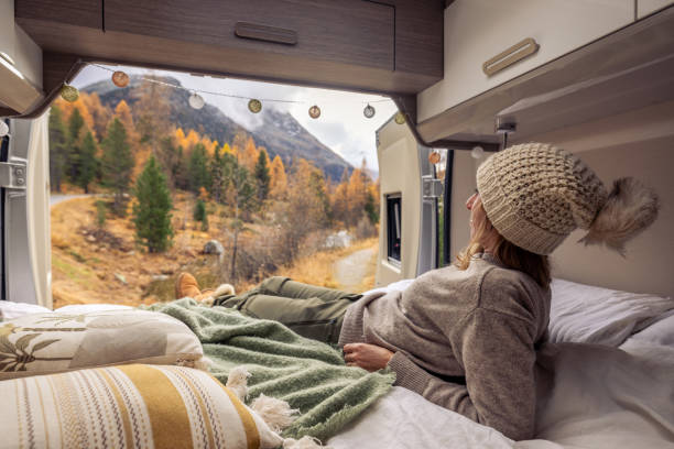 istock Woman Relaxing in Camper Van with Scenic Autumn View 2183209807
