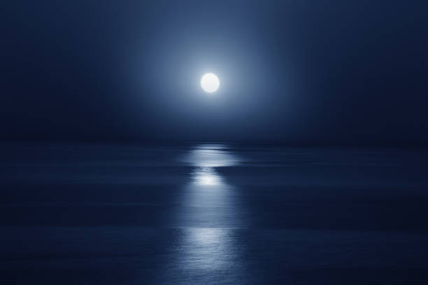 istock Deep blue moonlit ocean and sky at night 2183212802