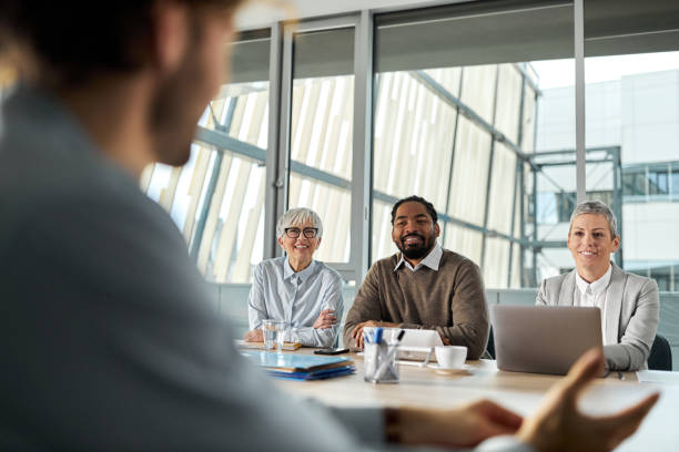 istock Happy business team talking to a candidate on a job interview. 2183214367