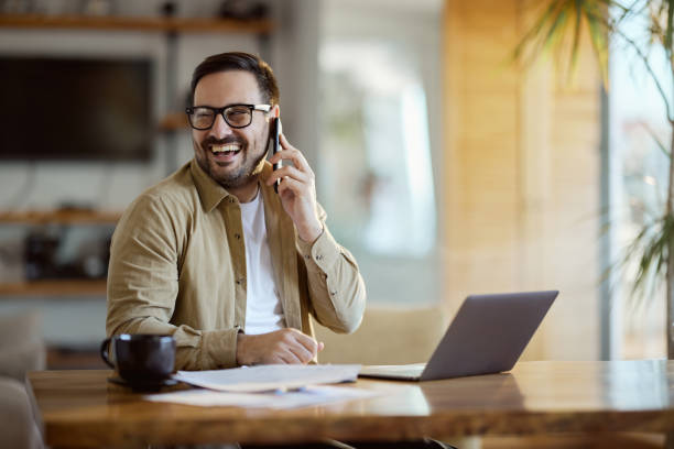 istock Happy businessman talking on mobile phone at home office. 2183214600