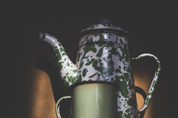 istock Vintage Enamel Teapot and Mug in Dramatic Lighting 2183216670