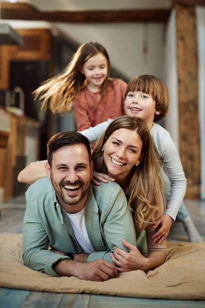 istock Happy family having fun on floor at home. 2183217333