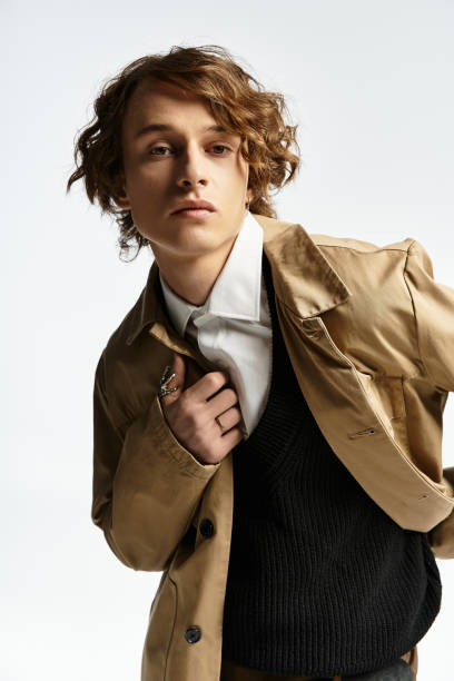 istock Handsome young man showcases stylish autumn outfit in a modern studio setting 2183217917