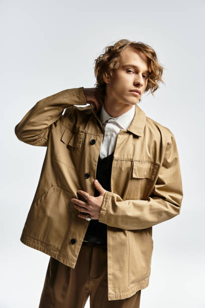 istock A handsome young man showcases a stylish autumn look in a bright studio setting 2183217929